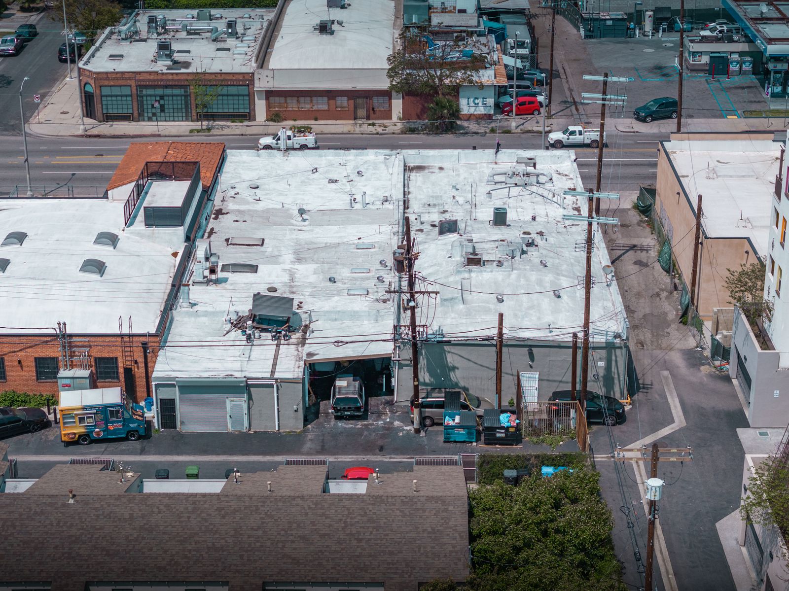 Aerial view of the back of the one-story building at 3612–3622 W Jefferson Blvd, showing flat roofs, the rear lot and the paved alley along one side.